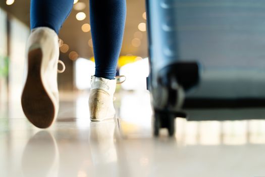 traveler with suitcase walking with carrying luggage and passenger for tour in the airport terminal for air traveling