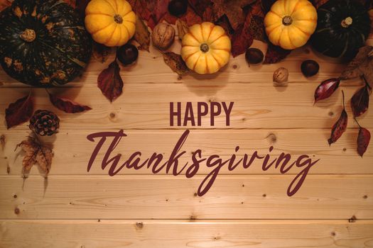 Happy Thanksgiving Day with pumpkin and nut on wooden background