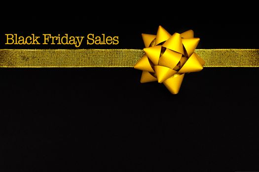 Black Friday sale, golden bow on black background