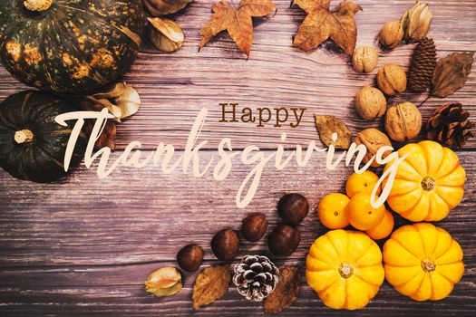 Happy Thanksgiving Day with pumpkin and nut on wooden table
