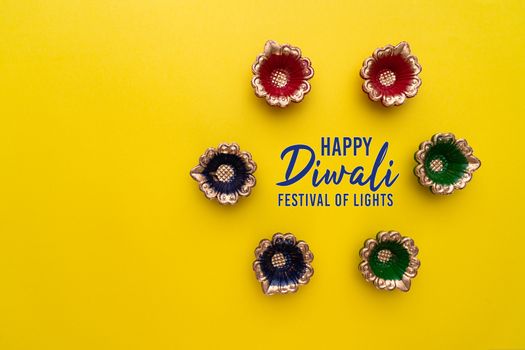 Happy Diwali - Clay Diya lamps lit during Dipavali, Hindu festival of lights celebration. Colorful traditional oil lamp diya