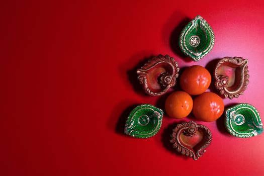 Happy Diwali - Clay Diya lamps lit during Dipavali, Hindu festival of lights celebration. Colorful traditional oil lamp diya