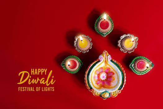 Happy Diwali - Clay Diya lamps lit during Dipavali, Hindu festival of lights celebration. Colorful traditional oil lamp diya