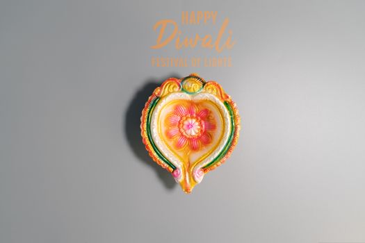 Happy Diwali - Clay Diya lamps lit during Dipavali, Hindu festival of lights celebration. Colorful traditional oil lamp diya