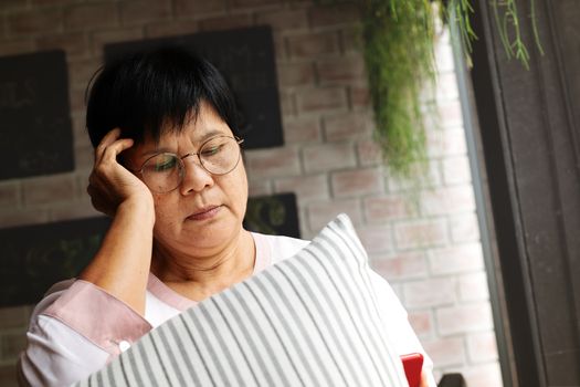 Frustrated older mature woman feeling boring desperate looking on the smartphone, stressed sad middle aged female depressed by hearing bad news