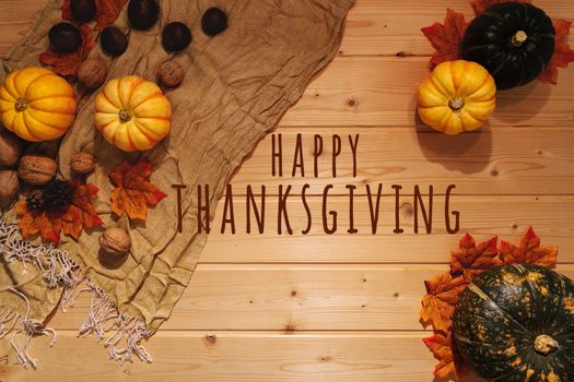Happy Thanksgiving Day with pumpkin and nut on wooden background