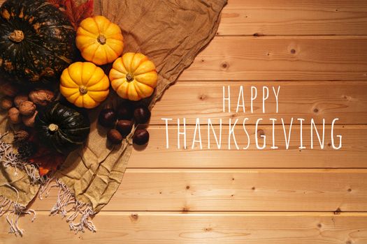 Happy Thanksgiving Day with pumpkin and nut on wooden background