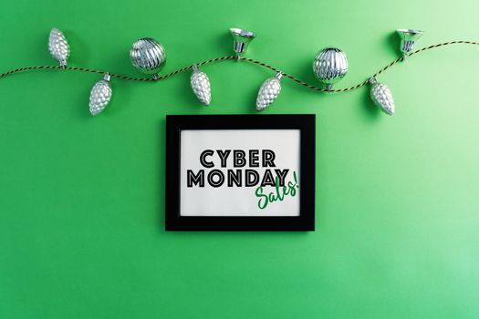 Cyber Monday Sale on photo frame with Christmas decoration on green background