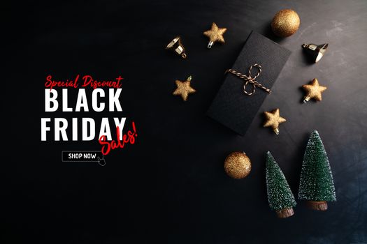gift box with Christmas decoration for Black Friday Sale concept on black background