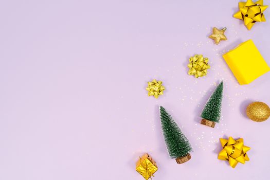 Christmas decoration. Gifts, yellow and golden decorations on purple background. Christmas, winter, new year concept. Flat lay, top view, copy space