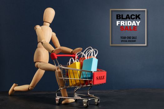 Black Friday sale, wooden door running with shopping cart