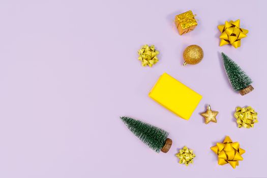 Christmas decoration. Gifts, yellow and golden decorations on purple background. Christmas, winter, new year concept. Flat lay, top view, copy space