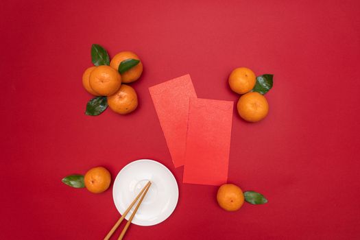 Flat lay Chinese lunar new year traditional food and offering red envelope on table top
