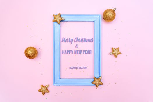 Christmas gold ball and star with photo frame on pink background