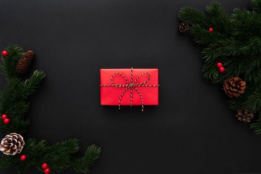 Christmas gift box and pine tree with xmas decoration on black background