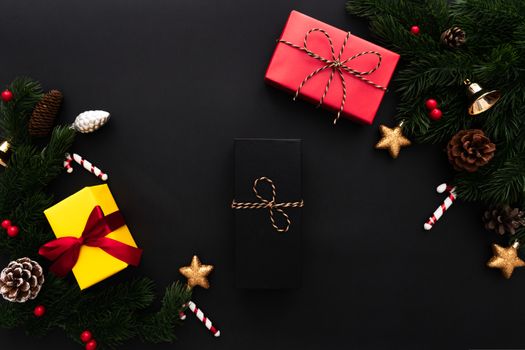 Christmas gift box and pine tree with xmas decoration on black background