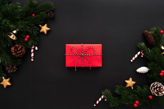 Christmas gift box and pine tree with xmas decoration on black background