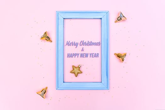 Christmas bell and star with photo frame on pink background