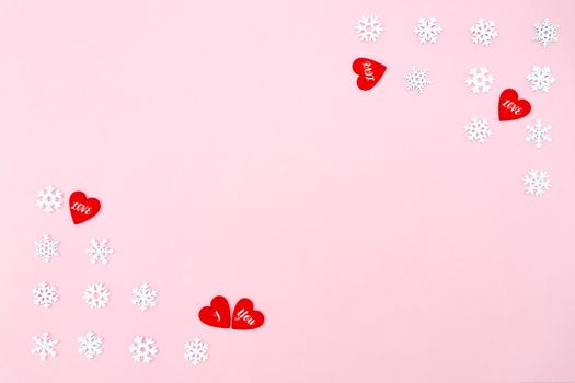 Valentine's Day background. red hearts and snowflakes on pink background. Valentines day concept. Flat lay, top view, copy space
