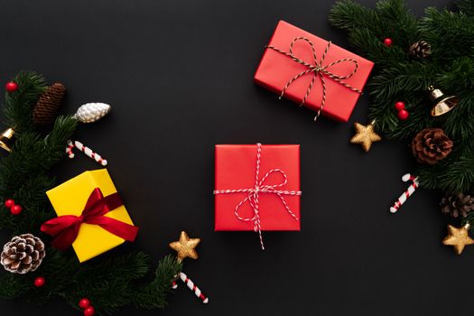 Christmas gift box and pine tree with xmas decoration on black background