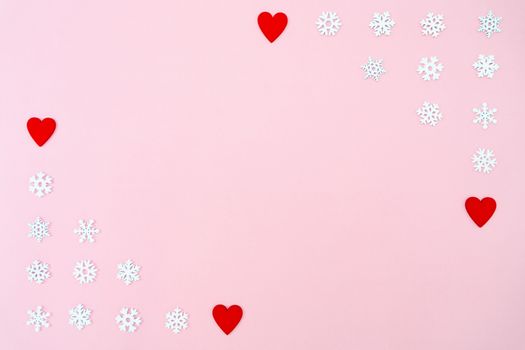 Valentine's Day background. red hearts and snowflakes on pink background. Valentines day concept. Flat lay, top view, copy space