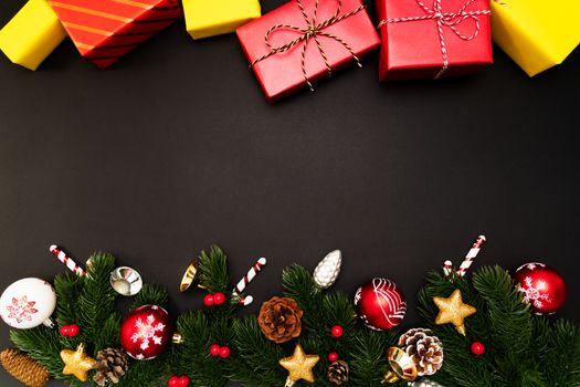 Christmas gift box and pine tree with xmas decoration on black background