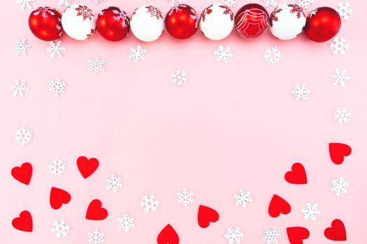 Christmas composition. Christmas balls, red heart and snowflakes decorations on pink background. Flat lay, top view, copy space