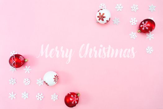 Christmas composition. Christmas balls and snowflakes decorations on pink background. Flat lay, top view, copy space