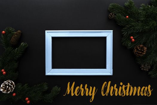 Christmas pine tree and photo frame with xmas decoration on black background