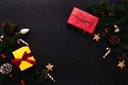 Christmas gift box and pine tree with xmas decoration on black background