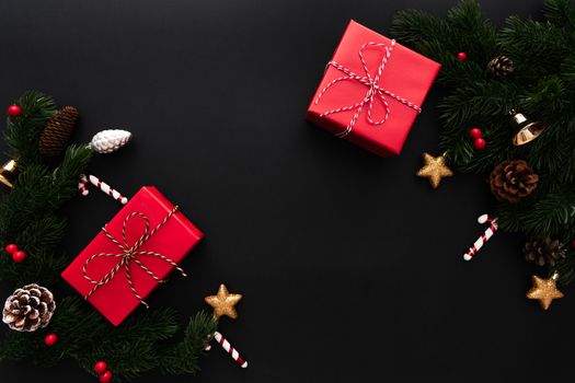 Christmas gift box and pine tree with xmas decoration on black background