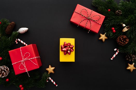 Christmas gift box and pine tree with xmas decoration on black background
