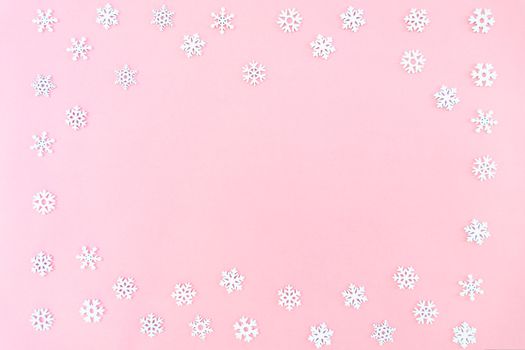 Christmas composition. Christmas snowflakes on pink background. Flat lay, top view, copy space