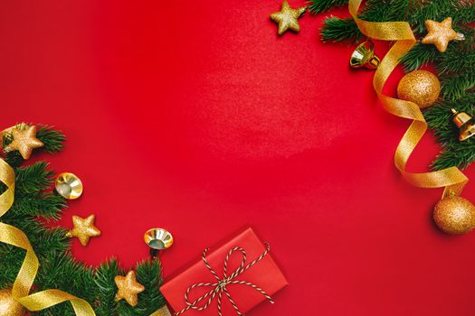 Christmas present and pine tree with xmas decoration on Red background