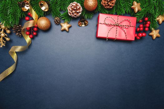 Christmas present and pine tree with xmas decoration on blue background