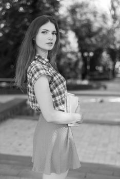 Girl student in skirt and plaid shirt. Kyiv. Ukraine