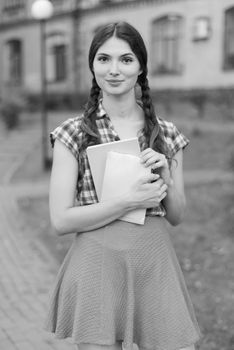 Girl student in skirt and plaid shirt. Kyiv. Ukraine