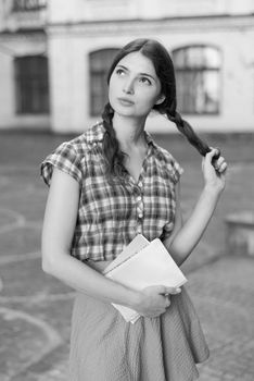 Girl student in skirt and plaid shirt. Kyiv. Ukraine