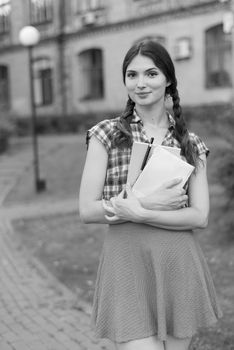 Girl student in skirt and plaid shirt. Kyiv. Ukraine