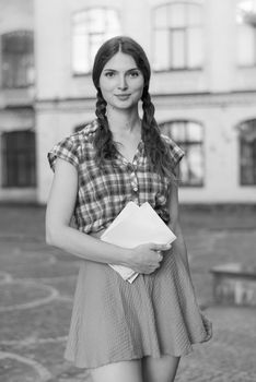 Girl student in skirt and plaid shirt. Kyiv. Ukraine