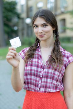 Young girl holding a condom. Protected sex