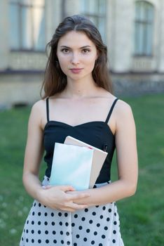 Young girl student with book and notebook