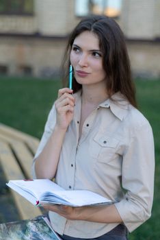 Young girl student with pen.