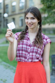 Young girl holding a condom. Protected sex