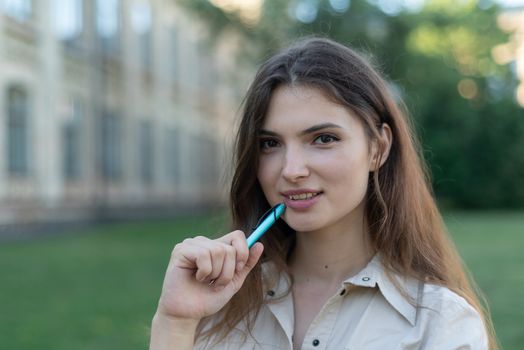 Young girl student with pen.