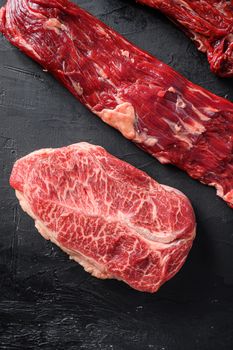Raw, alternative beef steaks flap flank Steak, machete steak or skirt cut, Top blade or flat iron beef and tri tip, triangle roast with denver cut . Black stone background. Top view