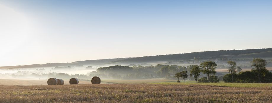 straw bales in early morning light on countryside of french normandy near calais and boulogne in parc naturel des caps et marais dopale