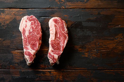 Fresh Chuck beef steak on vintage dark wood table Organic beef. Black Top view. Space for text,