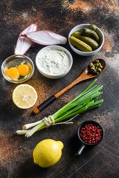 Ingredient tartar sauce organic mayonnaise, lemon,capers,parsley,dill,onion and various herbs. Over old rustic metall background Top view vertical.