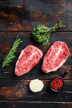 Top blade steak, bio raw meat, marbled beef . old wood table background. Top view.